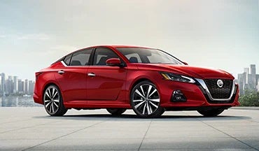2023 Nissan Altima in red with city in background illustrating last year's 2022 model in Nissan of Melbourne in Melbourne FL